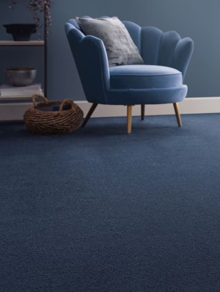 blue velvet armchair with blue carpet